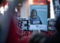 LONDON, UNITED KINGDOM - OCTOBER 09: A protester holds a poster of slain Palestinian-American journalist Shireen Abu Akleh outside the Israeli Embassy on October 09, 2023 in London, United Kingdom. The group is standing in solidarity with the resistance against Israeli apartheid and settler colonialism. (Photo by Leila Dougan/Gallo Images via Getty Images)
